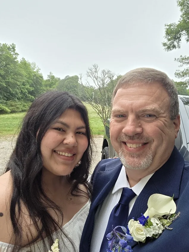 Donald and Marcela Colbert, owners of Colombian Street LLC, smiling together outdoors.